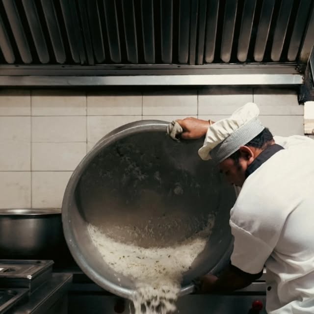 Cook preparing food in the Tiranga Bhuvan restaurant kitchen