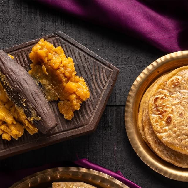 Puran poli pieces plated with saffron and nuts in a food photograph